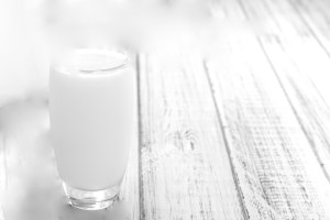 Portion of Milk on wooden background (close-up shot)